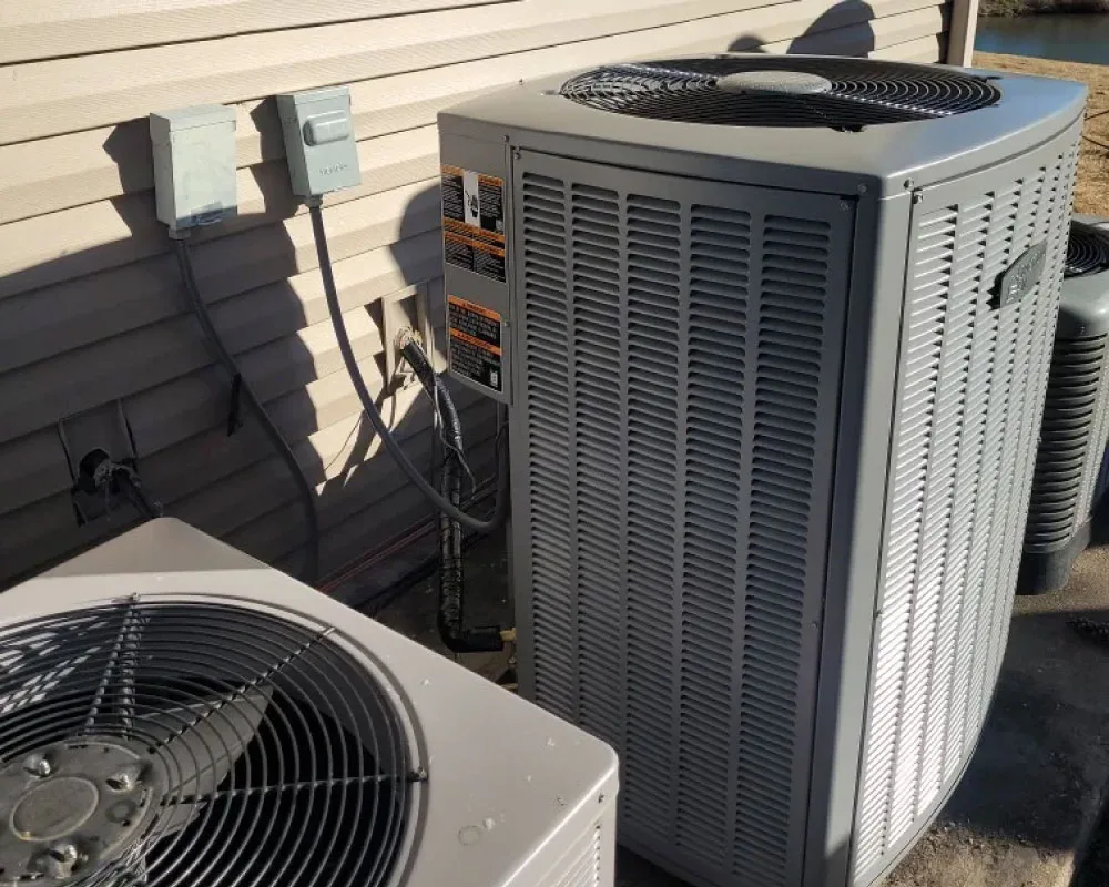 Outdoor air-conditioning condenser unit installed beside a home