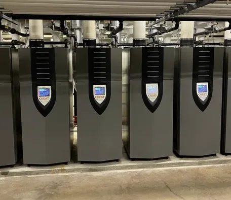 Bank of high-efficiency wall-mounted boilers in a mechanical room
