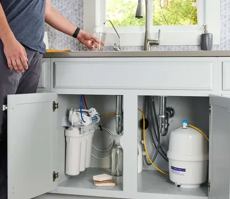 Reverse osmosis drinking water system installed under a kitchen sink